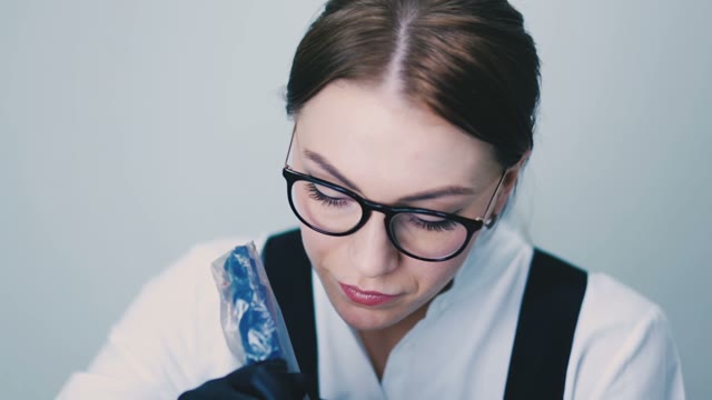 Woman Working With A Tattoo Machine Close-up