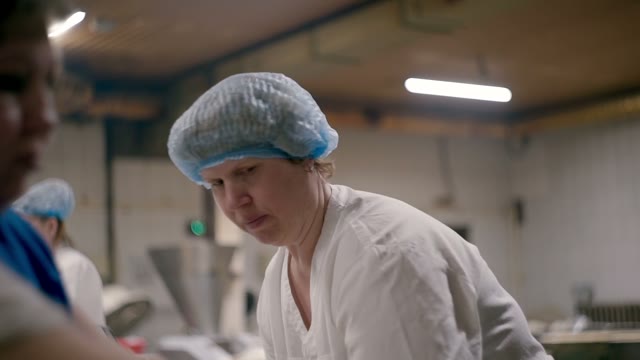 Women And The Dough From Conveyor