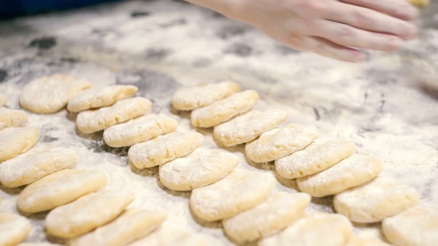 Woman Rolls The Dough With Hands