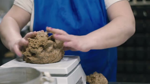 The Woman Moistens The Dough With Water