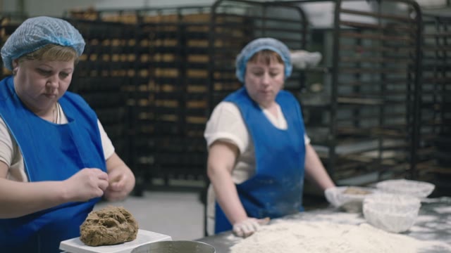 Woman Puts The Dough Into The Flour