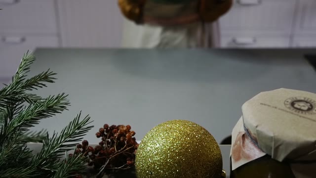 Woman Puts A Pumpkin On The Table