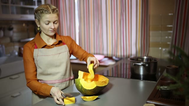 Woman Cuts A Pumpkin