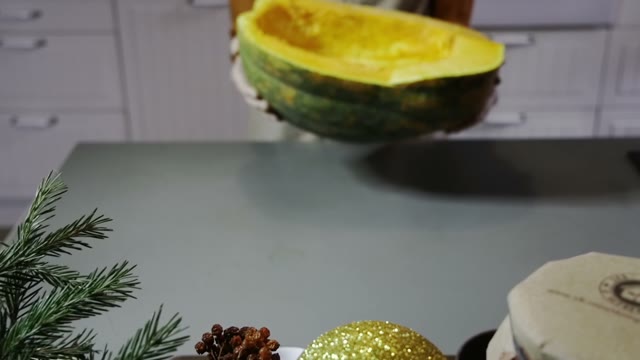 Woman Puts A Pumpkin On The Table Close Up