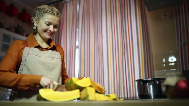 Housewife Cuts A Pumpkin On The Table