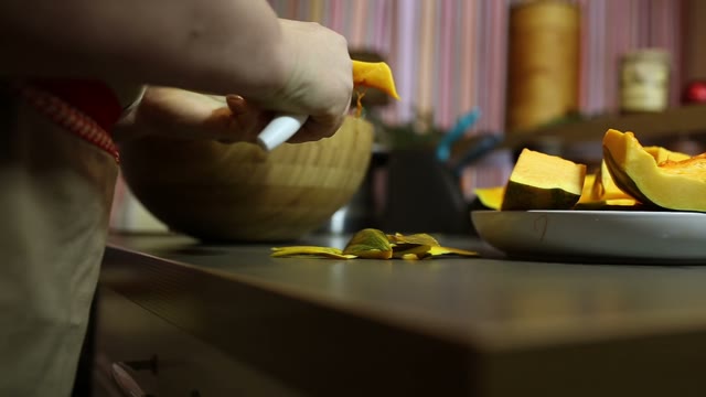 Woman Is Cleaning Pumpkin Slices