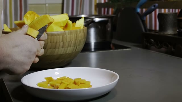 Woman Slices Pumpkin Slices With A Knife