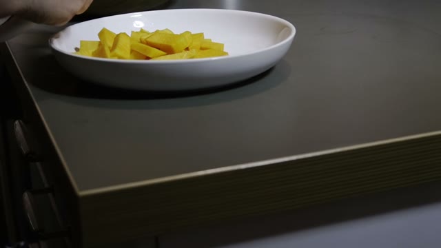 Slices Of Pumpkin Fall Into A Plate