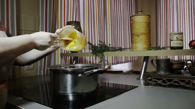 Woman Pours A Pumpkin Flesh Into A Pan