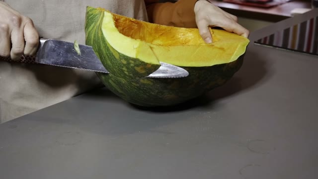 Knife Cuts A Pumpkin Into Pieces