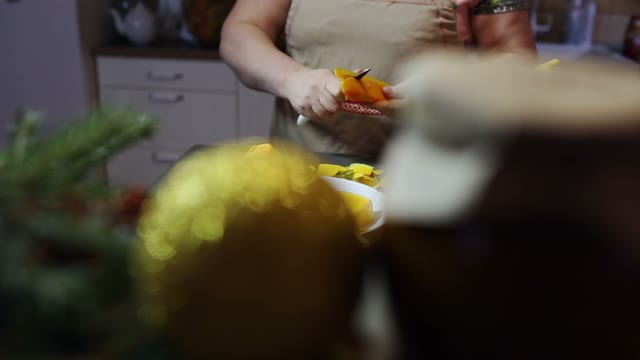 Woman Is Cutting A Pumpkin In Her Hands