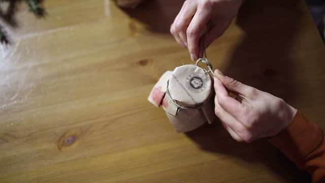 Woman Tie A Package On A Jar