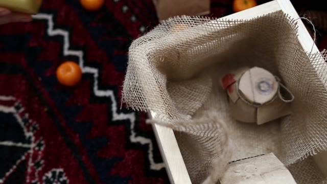 Woman's Hand Puts A Jar Of Honey In A Box