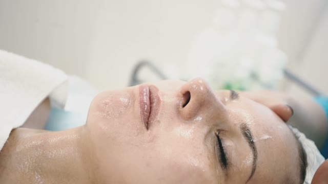 Woman Treats Face With Quality Spa Creams
