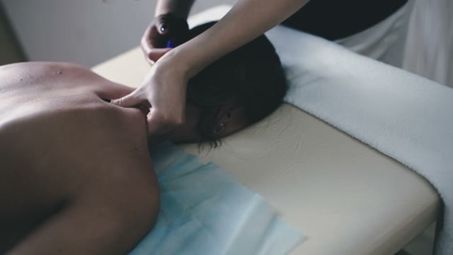 The Masseuse Relaxes The Neck Muscles