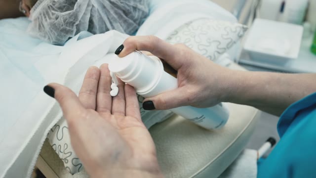 Salon Worker Puts Cream On Hands