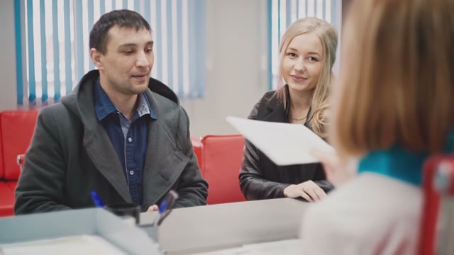 Man And A Woman Are Studying Papers