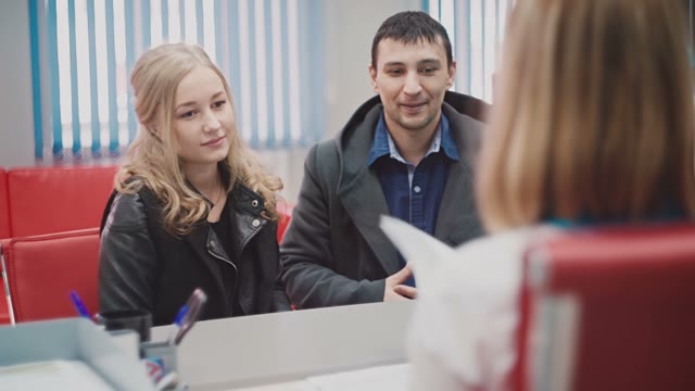 Man And A Girl In A Bank Take Papers