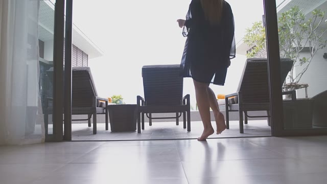 Girl In A Dress Goes Out Onto The Veranda