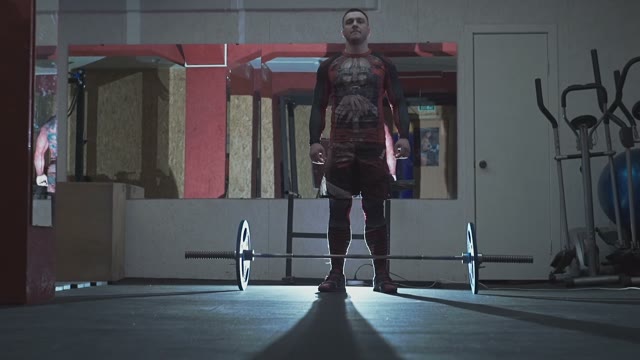 Athlete Is Standing On The Floor Above The Barbell
