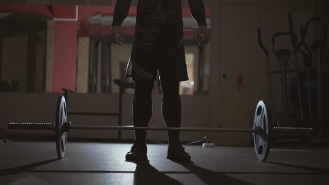 Athlete Stands Over The Barbell