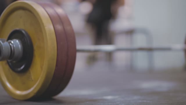 Barbell Rests On The Floor In The Gym