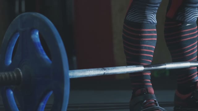 Man Is Standing Near The Barbell
