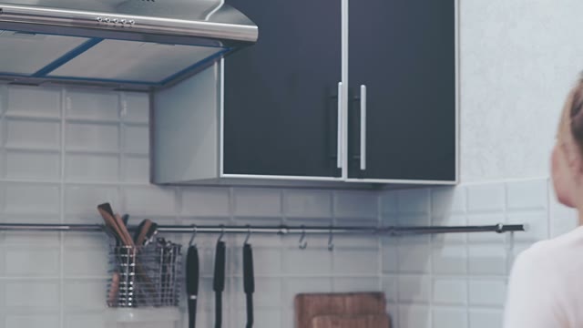 Woman Opens The Cupboard And Smiling
