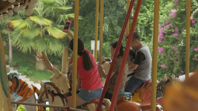 People Ride Carousel