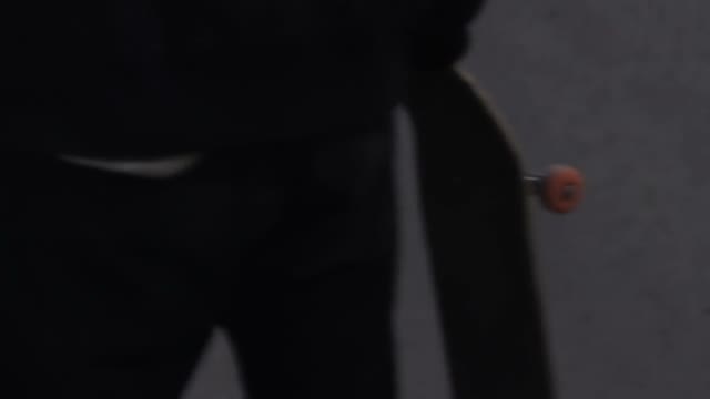 Man Twists A Skateboard Close-up