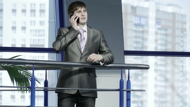Young Businessman In A Suit Talking On The Phone