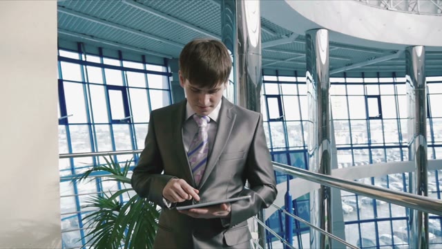 Businessman In A Business Center Of The Tablet