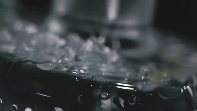 Water Is Poured Into A Flask With Mint
