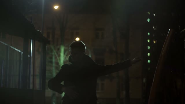 Young Guy In A Coat Performs Movements