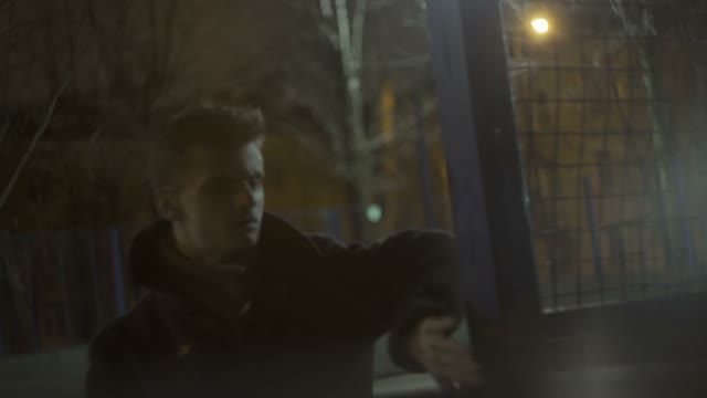 Young Guy In A Coat Makes Sharp Movements