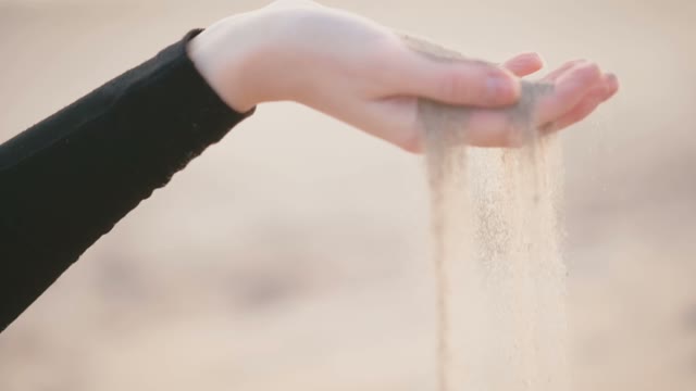 Sand Falls From The Woman's Palm