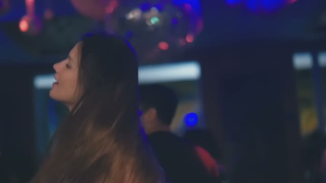 Girl Shakes Her Hair Dancing In The Club