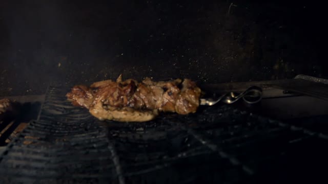 Piece Of Meat Is Fried On A Grate