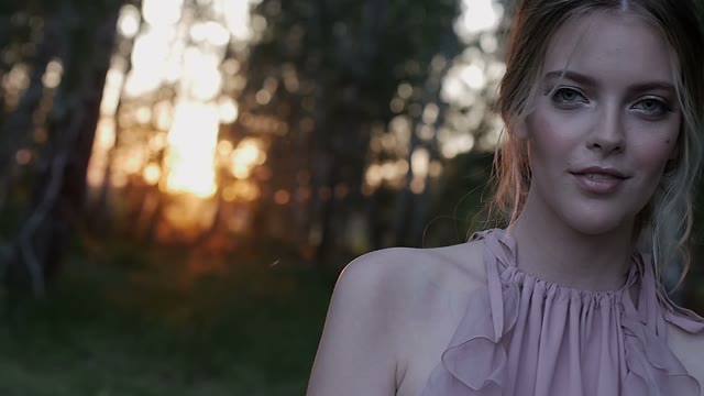 Girl Stands In The Woods And Smiles