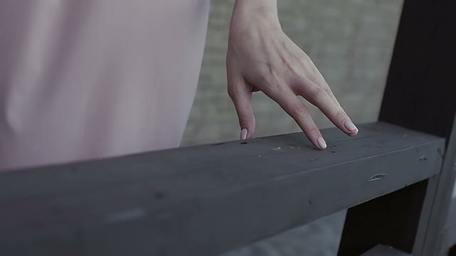 Girl Is Driving Her Hand Around The Railing