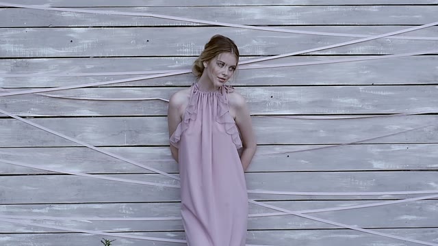 Girl Is Standing By The Wall And Looking Away