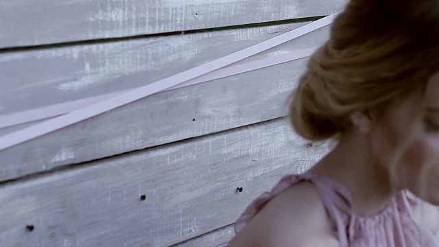 Girl Leans Against The Wall And Looks At The Camera