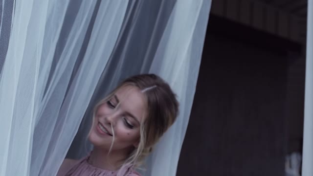 Girl Is Standing At The Curtain And Smiling