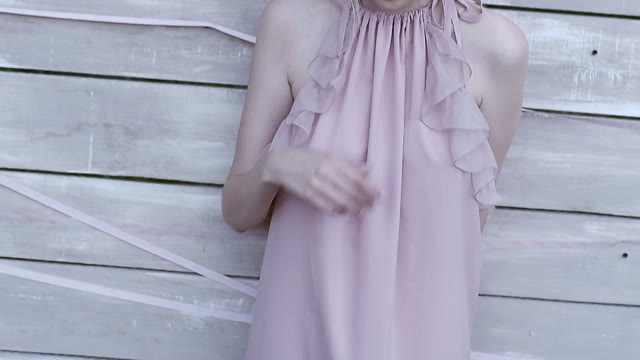 Girl Adjusts Her Hair With Her Hand And Looks At The Camera