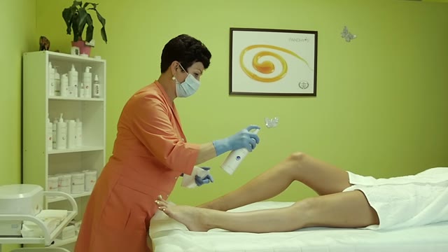 Woman Sprinkles A Remedy On The Client Legs
