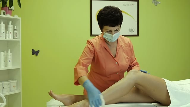 Woman Is Wiping A Client's Legs With A Napkin