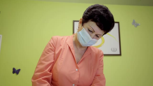 Woman In A Mask Works With Concentration