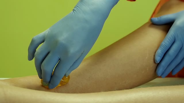 Woman Smears The Sugar Liquid For Shugaring On Her Legs