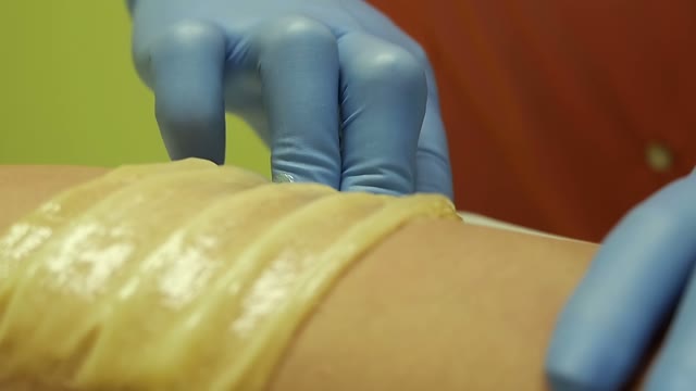 Woman In Blue Gloves Tears A Sugar Strip