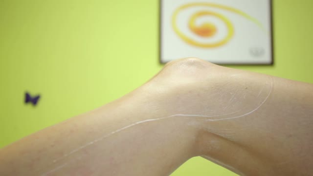 Woman In Gloves Smears Her Feet With Cream